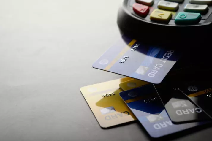 imagem de cartão de crédito sendo inserido em maquininha de compra